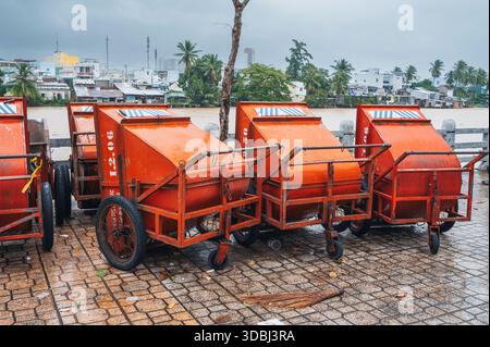Aprire i contenitori di raccolta rifiuti metallici vuoti. Una fila di bidoni vuoti sulla spiaggia. Nha Trang, Vietnam - 13 dicembre 2024. Foto Stock