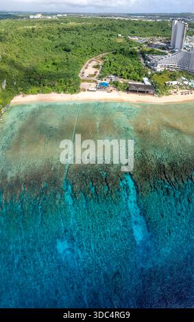 Un panorama aereo verticale di Gun Beach all'estremità settentrionale di Tumon Bay sull'isola di Guam, Micronesia. Il taglio dritto e distintivo attraverso Foto Stock