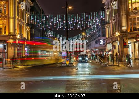 Luci di Natale di Oxford Circus, autobus di Londra e percorsi leggeri, Oxford Street, Londra, Inghilterra, Regno Unito. Inverno. Scena notturna. Foto Stock