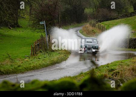 07/12/25 Felix von Haniel e Max von Doderer, 1967 Jaguar S Type 3,8 combattendo contro concorrenti di pioggia torrenziale alla guida di 60 auto d'epoca Foto Stock