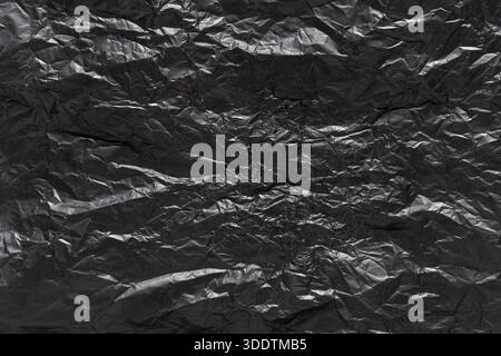 Carta ruvida nera con ombre e luci sottili. Foto Stock