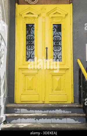Porta della casa vintage gialla e scala di chiusura Foto Stock