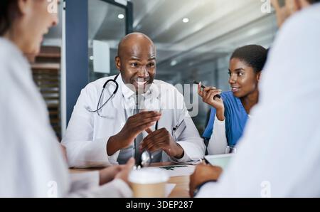 Medico, conversazione e uomo in ospedale per ricerca medica, collaborazione e brainstorming. Incontro sanitario, persone e infermieri in clinica con Foto Stock