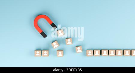 Cubi di legno con magnete rosso e icone umane su sfondo blu. Concetto di generazione di lead, attrazione per i clienti, reclutamento delle risorse umane e. Foto Stock