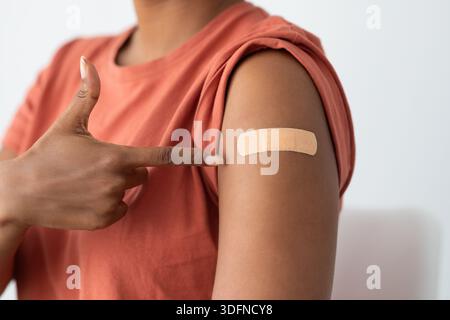 Paziente irriconoscibile che punta alla fascia mediale sul braccio Foto Stock