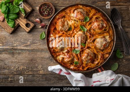 polpette in nidi di pasta con salsa di pomodoro, vista dall'alto, sfondo in legno Foto Stock