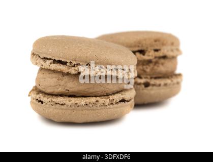 Un paio di biscotti di macaroon francesi marroni su sfondo bianco Foto Stock