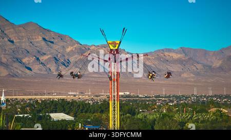 Giro aereo in Swing Ride per il Carnevale di Las Vegas Fair Attraction con sfondo Desert Mountain Foto Stock