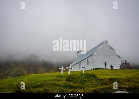In un angolo molto remoto dell'Islanda, abbiamo visitato una chiesa e un museo e ci siamo imbattuti in questo piccolo cimitero nella bassa nebbia. Foto Stock