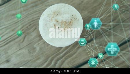 Mostra una tazza bianca ricoperta di latte schiumoso e cacao su un tavolo di legno, mostrando le esicone mediche color tè Foto Stock