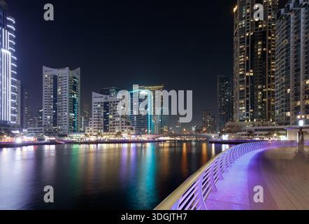 Dubai Marina, Emirati Arabi Uniti - 13 marzo 2025: Dubai Marina presenta splendidi grattacieli e luci vibranti che si riflettono sull'acqua di notte Foto Stock