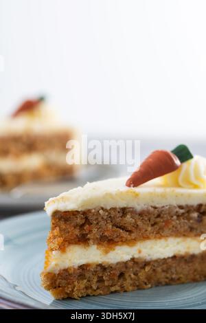 Fetta di torta di carote con glassa di formaggio cremoso su un tavolo di legno Foto Stock