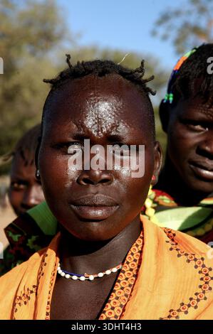 Un ritratto di una donna Karimojong a Kotido, Karamoja, Uganda, con abbigliamento tradizionale, identità culturale, e la resilienza della vita pastorale Foto Stock