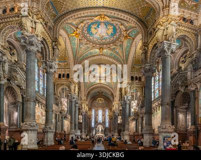 Lione, Francia - 10 23 2025: Basilica di nostra Signora di Fourvière. Vista panoramica della navata, delle navate con vetrate colorate e abside sul retro Foto Stock