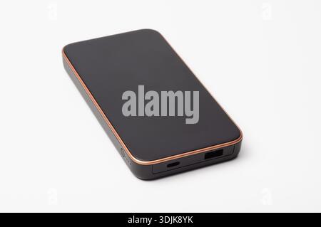 Un power Bank moderno e sottile con finitura opaca scura e eleganti dettagli metallici, perfetto per le soluzioni di ricarica in movimento Foto Stock