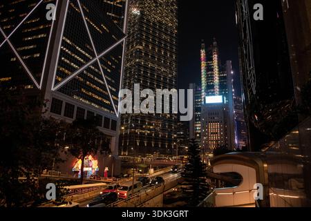 La vivace città centrale di Hong Kong, l'edificio principale HSBC e altri sono illuminati di notte. Foto Stock