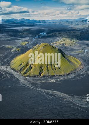 Vista aerea delle pendici verdeggianti ricoperte di muschio del monte Maelifell che si innalzano drammaticamente dalle sabbie vulcaniche nere, Skaftárhreppur, Icelan Foto Stock