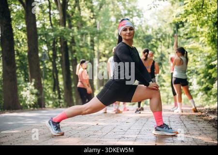 Prepararsi per la maratona facendo esercizi caldi. Un gruppo di corridori si trova all'aperto. Foto Stock