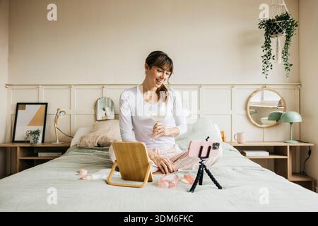 Donna che crea contenuti video di bellezza per la cura della pelle per i social media Foto Stock