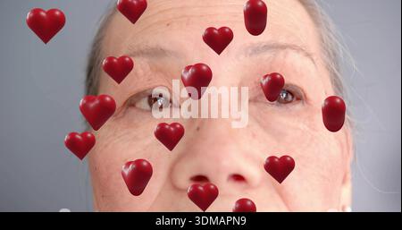 Sembra una donna cinese anziana che riempie la maggior parte della cornice in studio, con sovrapposizioni cardiache 3D rosse Foto Stock
