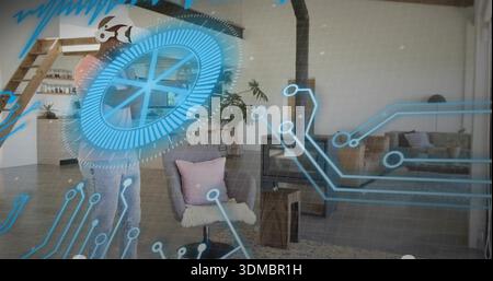 Uomo con gesti che indossa un visore VR e una felpa con cappuccio, utilizzando l'interfaccia olografica a casa Foto Stock