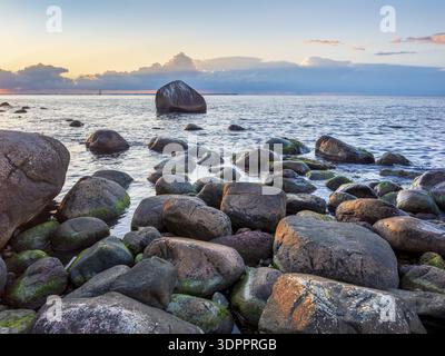 Tramonto sul Mar Baltico, massi sulla riva, Schwanensteint sul retro, Lohme, Jasmund National Park, Ruegen Island, Meclemburgo-Pomerani occidentale Foto Stock