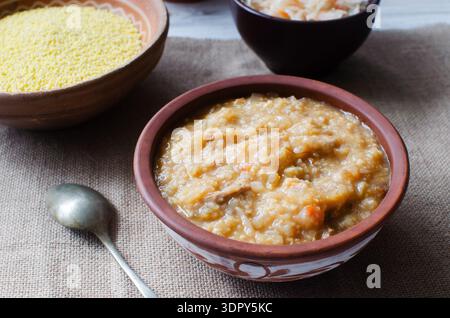 Zuppa - kapustnyak in una ciotola di ceramica su sfondo burlap. Zuppa di crauti, miglio e pollo fatto in casa. Concetto di cucina Ucraina tradizionale. Foto Stock