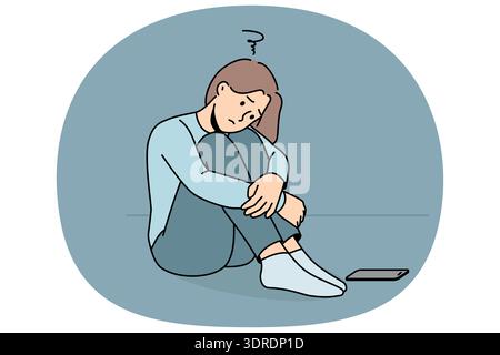 La donna triste aspetta una telefonata, sta seduta per terra e soffre di solitudine o di mancanza di amici Foto Stock