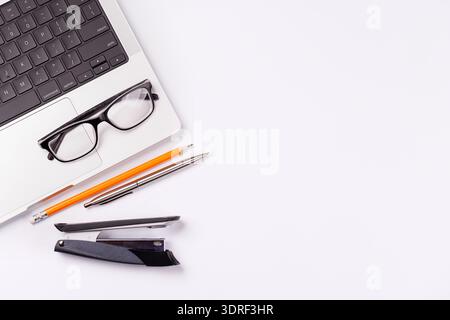 Scrivania con computer portatile e articoli da ufficio Foto Stock