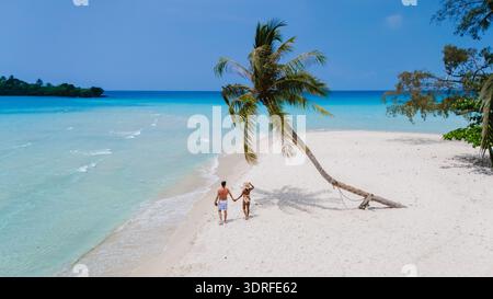 Coppia felice di godersi una bella passeggiata mano nella mano sulla splendida spiaggia dell'isola di Koh Kood Foto Stock
