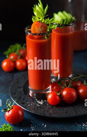 Bicchieri di succo di pomodoro serviti con cetriolo e sedano Foto Stock