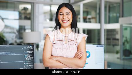 Donna felice, ritrattista e analista di dati con fiducia in ufficio per la gestione del software. Donna, dipendente o programmatore con sorriso o braccia Foto Stock