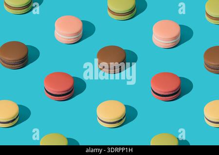 Macaron francesi colorati su sfondo turchese con ombre chiare. Concetto creativo di cibo. Piatto dolce minimo da dessert. Foto Stock