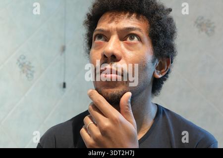 Uomo che guarda in alto, nel profondo del pensiero, del brainstorming e della pianificazione Foto Stock