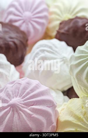 Un gruppo di morbidi marshmallow multicolori disposti insieme, che mostrano la loro consistenza soffice e le vibranti tonalità pastello. Primo piano, cibo astratto Foto Stock
