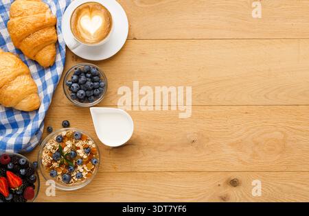 Colazione a buffet con caffè, pasticcini e frutta fresca su un tavolo di legno in un intimo ambiente da Cafe' Foto Stock