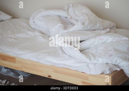 La lettiera su un letto di legno mostra segni di utilizzo e movimento Foto Stock