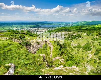 Cheddar Gorge e Cheddar, Somerset - Vista dalla cima della Gola di Cheddar alla città di Cheddar in una bella giornata estiva. Foto Stock
