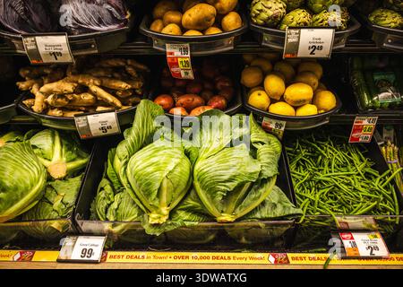 Lockport, New York, USA, 10 ottobre 2025: Cavolo verde fresco e verdure assortite esposte su uno scaffale di un negozio di alimentari negli Stati Uniti Foto Stock