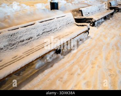 Lunga panchina di legno ricoperta di neve sul Boulevard Gogolevsky nella città di Mosca la notte d'inverno Foto Stock