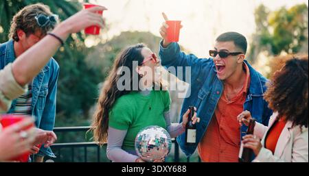 Persone all'aperto, feste o felici con drink sul balcone, brindisi o riunioni sociali per festeggiare il fine settimana. Ritrovo, riunione o gruppo di amici Foto Stock