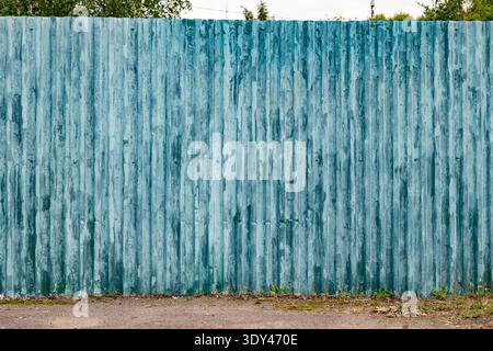Pannello di recinzione in metallo ondulato con vernice blu resistente agli agenti atmosferici e sfondo ruggine Foto Stock
