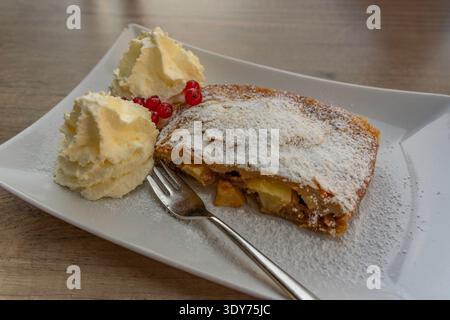 Strudel di mele tradizionale servito con panna a Bruckberg, Salisburgo, Austria, durante un pomeriggio di sole Foto Stock