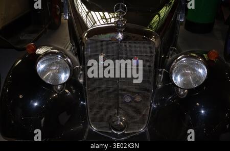 Primo piano dell'iconica calotta a stella a tre punte Mercedes-Benz e della griglia del radiatore cromata su un modello vintage da 170 V di Belgrado Auto Foto Stock