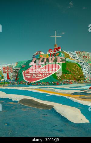 Colorate strutture d'arte popolare e dipinte a lato della collina a Salvation Mountain vicino al Mare di Salton, nella California meridionale, USA. Foto Stock