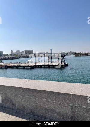 Barche tradizionali in dhow e acque del porticciolo a Doha Corniche con il moderno skyline della città, Doha, Qatar Foto Stock