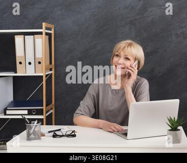 Imprenditore maturo di successo che parla al telefono Foto Stock