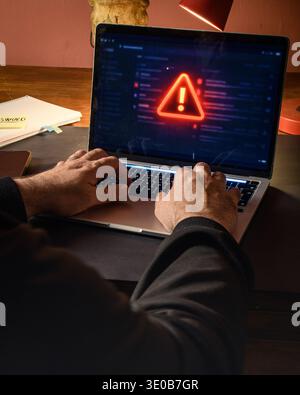 Mani su un notebook con un avviso rosso sullo schermo, immagine concettuale di cyber incidente, avviso di malware, errore di sistema e minaccia digitale. Foto Stock