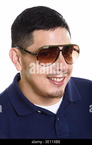 Volto del giovane ispanica felice uomo sorridente indossando occhiali da sole Foto Stock