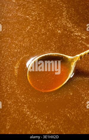 Salsa al caramello salata in un cucchiaio di metallo da vicino Foto Stock
